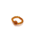 Masažinis gintaro žiedas medaus spalva, Amber massage ring in honey color.